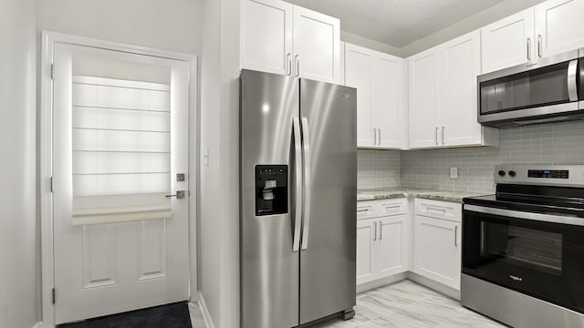 34 Herons Watch Way Unit 1202, Santa Rosa Beach, FL 32459 - kitchen featuring appliances with stainless steel finishes, white cabinets, and decorative backsplash