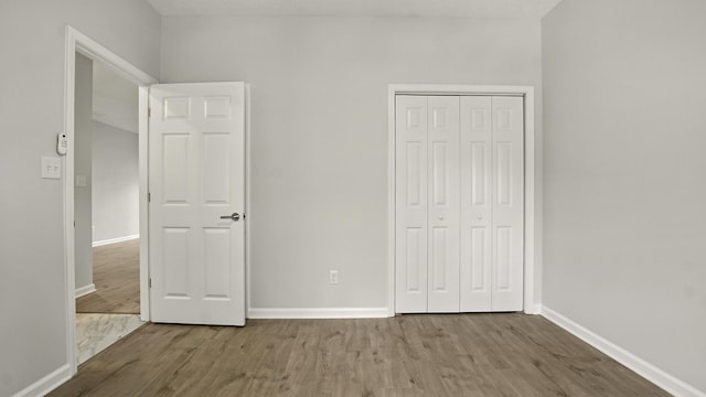 34 Herons Watch Way Unit 1202, Santa Rosa Beach, FL 32459 - unfurnished bedroom featuring wood finished floors and a closet