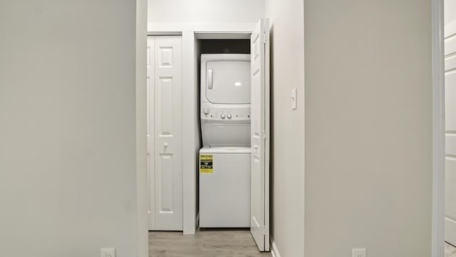 34 Herons Watch Way Unit 1202, Santa Rosa Beach, FL 32459 - washroom with stacked washer and clothes dryer and light wood-style flooring
