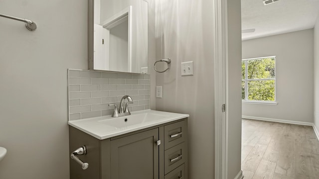 34 Herons Watch Way Unit 1202, Santa Rosa Beach, FL 32459 - bathroom featuring decorative backsplash, vanity, and wood finished floors