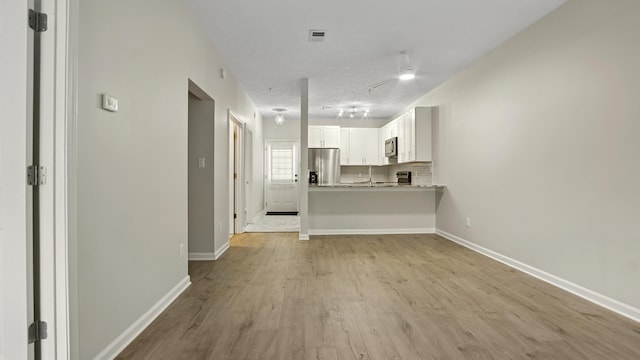 34 Herons Watch Way Unit 1202, Santa Rosa Beach, FL 32459 - unfurnished living room with light wood finished floors and a ceiling fan