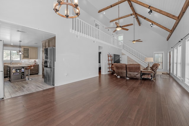 6539 Robar Tesora St, Navarre, FL 32566 - living area featuring high vaulted ceiling, a chandelier, wood finished floors, a ceiling fan, and beamed ceiling