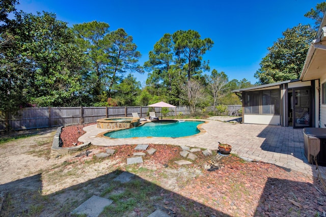 6539 Robar Tesora St, Navarre, FL 32566 - view of pool with a sunroom, a fenced backyard, a patio area, and a pool with connected hot tub