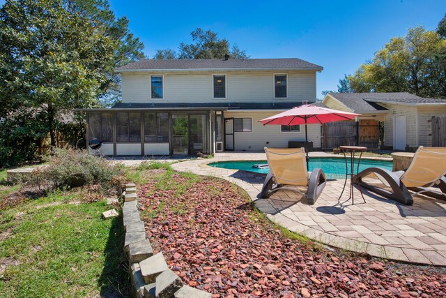 6539 Robar Tesora St, Navarre, FL 32566 - back of property with a sunroom, an outdoor pool, and a patio area