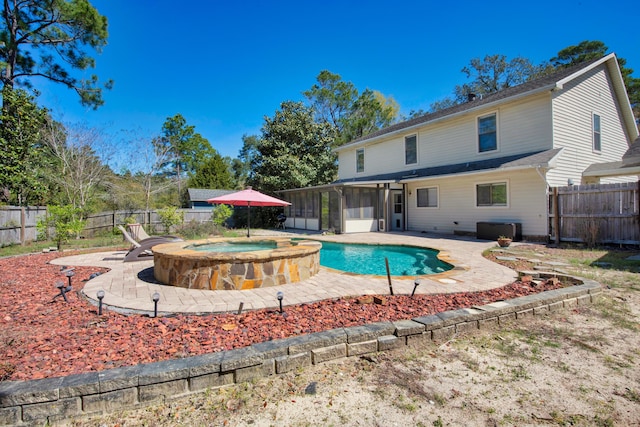 6539 Robar Tesora St, Navarre, FL 32566 - view of swimming pool featuring a sunroom, a fenced backyard, a patio area, and a pool with connected hot tub