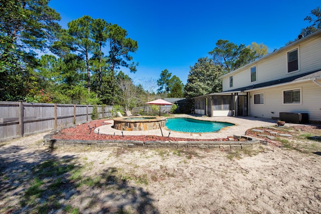 6539 Robar Tesora St, Navarre, FL 32566 - view of swimming pool with a sunroom, a fenced backyard, a pool with connected hot tub, and a patio