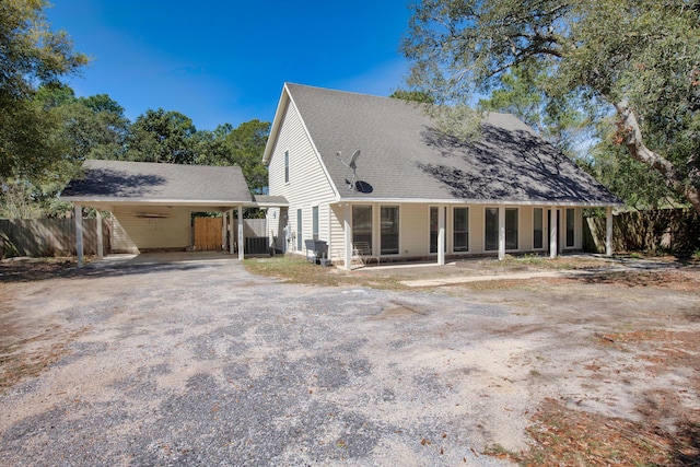 6539 Robar Tesora St, Navarre, FL 32566 - rear view of property featuring a carport and driveway