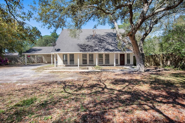 6539 Robar Tesora St, Navarre, FL 32566 - rear view of house featuring driveway, an attached carport, and roof with shingles