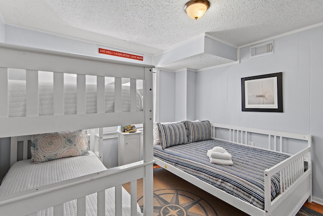 8009 E County Highway 30a, Inlet Beach, FL 32461 - bedroom with a textured ceiling, wood finished floors, and a decorative wall