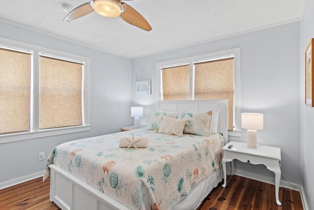 8009 E County Highway 30a, Inlet Beach, FL 32461 - bedroom featuring wood finished floors, multiple windows, a ceiling fan, and a textured ceiling