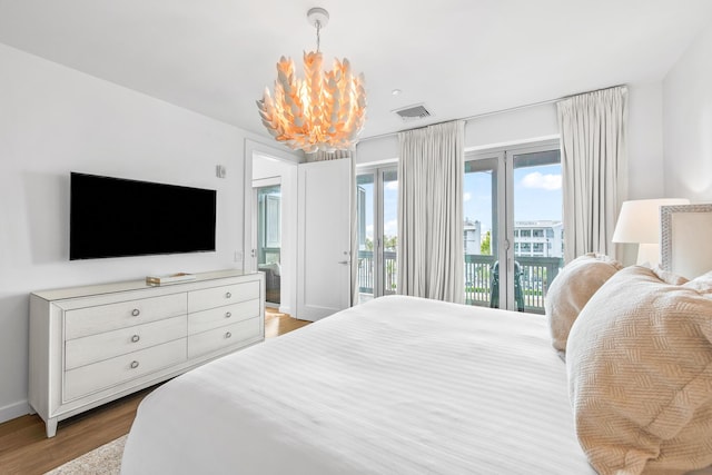 20 Mark Twain Ln Unit 402, Inlet Beach, FL 32461 - bedroom with access to exterior, a chandelier, and wood finished floors