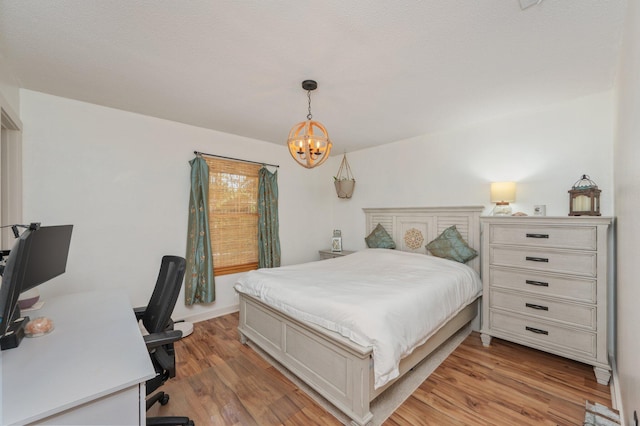 313 Lakeview Dr, Crestview, FL 32536 - bedroom with a chandelier, light wood-style flooring, and an office area