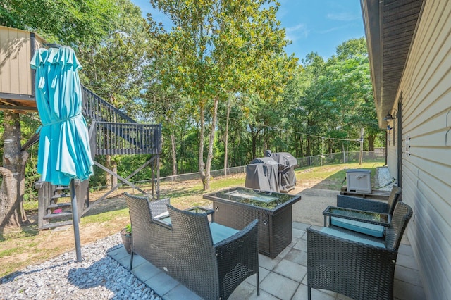313 Lakeview Dr, Crestview, FL 32536 - fenced backyard featuring stairway, a patio area, grilling area, and view of scattered trees