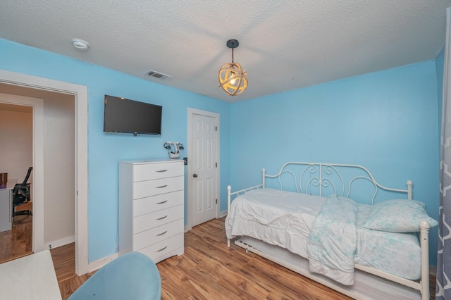 313 Lakeview Dr, Crestview, FL 32536 - bedroom with wood finished floors and a textured ceiling