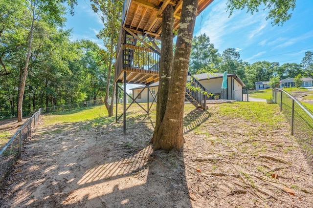 313 Lakeview Dr, Crestview, FL 32536 - fenced backyard with stairs, a deck, and view of scattered trees