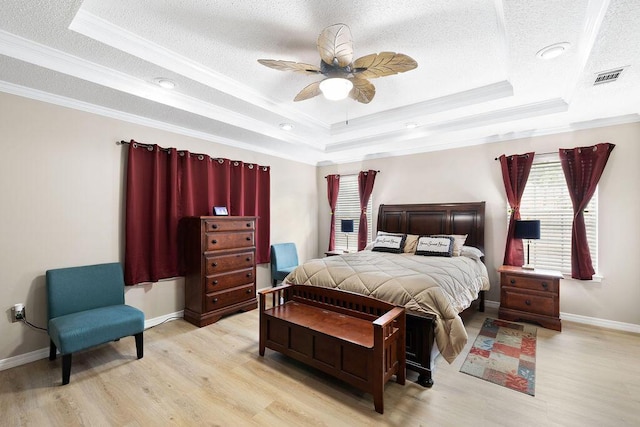 131 Wedgewood Ln, Crestview, FL 32536 - bedroom featuring a raised ceiling, wood finished floors, a textured ceiling, ornamental molding, and ceiling fan