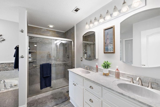 131 Wedgewood Ln, Crestview, FL 32536 - full bath with a stall shower, double vanity, a bath, and a textured ceiling