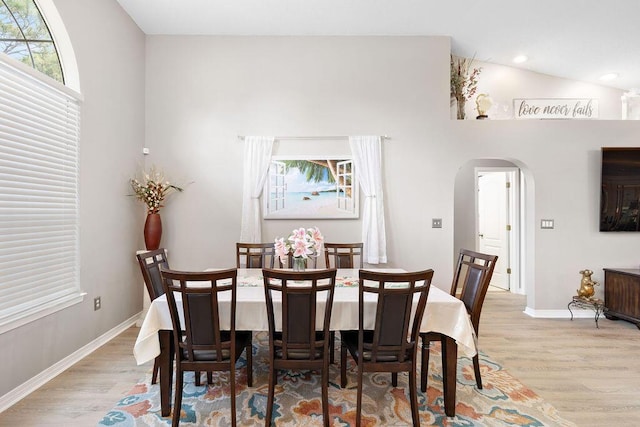 131 Wedgewood Ln, Crestview, FL 32536 - dining area featuring light wood-type flooring, arched walkways, recessed lighting, and high vaulted ceiling