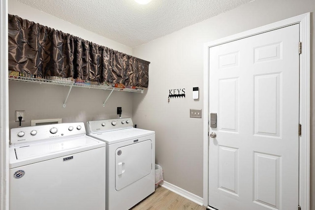 131 Wedgewood Ln, Crestview, FL 32536 - laundry room featuring independent washer and dryer, light wood-type flooring, and a textured ceiling