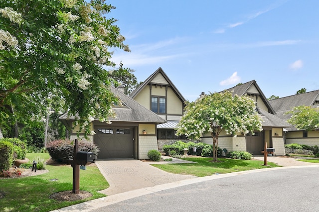 1510 Match Point Ln Unit 303, Panama City Beach, FL 32413 - view of front of property with driveway, a shingled roof, an attached garage, and a front lawn