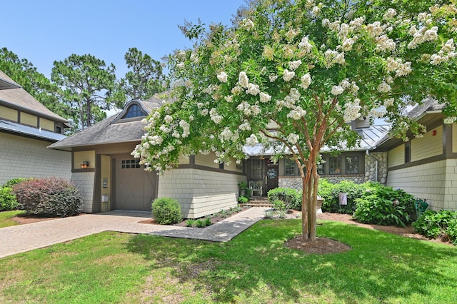 1510 Match Point Ln Unit 303, Panama City Beach, FL 32413 - view of front facade with a front yard, a garage, and decorative driveway