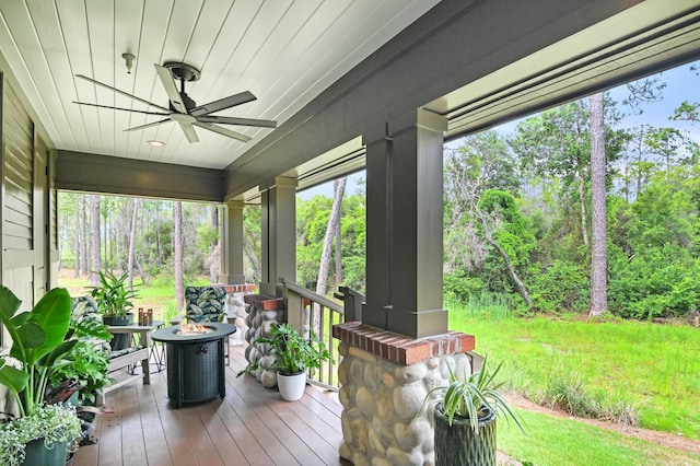 1510 Match Point Ln Unit 303, Panama City Beach, FL 32413 - sunroom featuring a ceiling fan, a fire pit, and view of wooded area