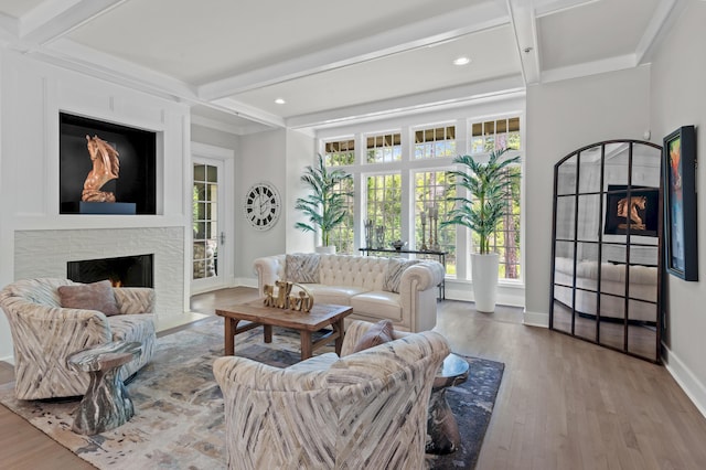 1510 Match Point Ln Unit 303, Panama City Beach, FL 32413 - living room with a fireplace with flush hearth, healthy amount of natural light, wood finished floors, beamed ceiling, and recessed lighting