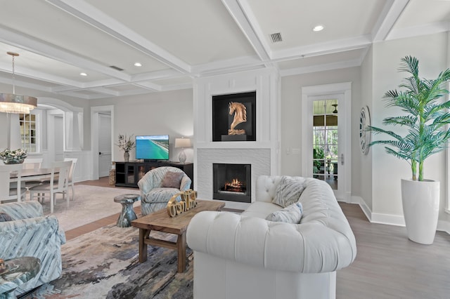 1510 Match Point Ln Unit 303, Panama City Beach, FL 32413 - living area with a warm lit fireplace, coffered ceiling, wood finished floors, beamed ceiling, and recessed lighting