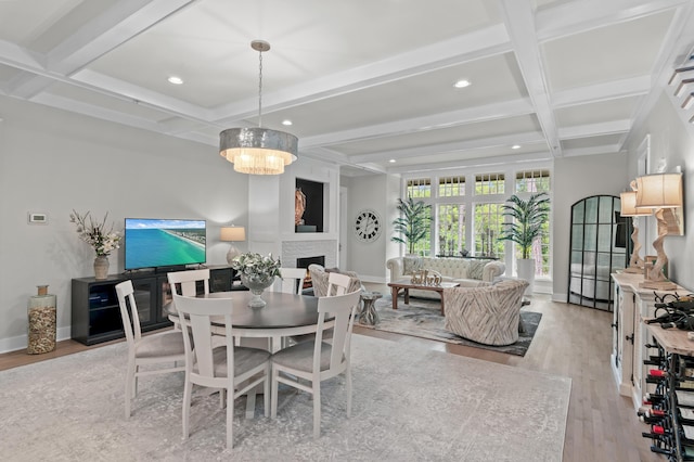 1510 Match Point Ln Unit 303, Panama City Beach, FL 32413 - dining room with coffered ceiling, light wood-style flooring, recessed lighting, a fireplace, and beam ceiling