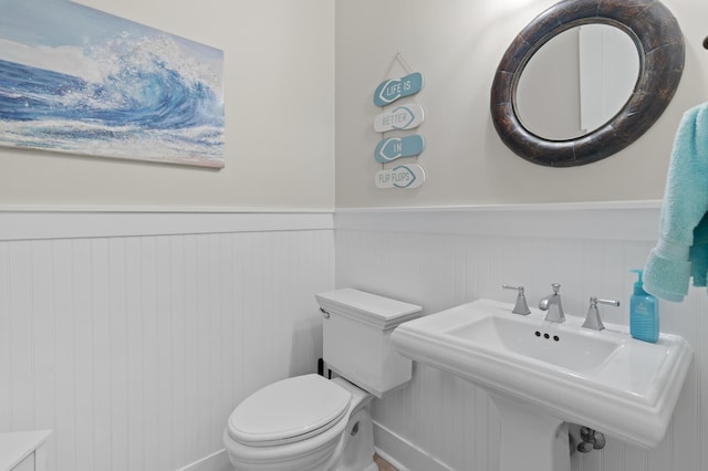1510 Match Point Ln Unit 303, Panama City Beach, FL 32413 - half bath with toilet and a wainscoted wall