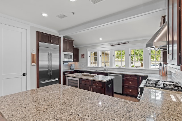 1510 Match Point Ln Unit 303, Panama City Beach, FL 32413 - kitchen with built in appliances, tasteful backsplash, light stone countertops, recessed lighting, and ornamental molding