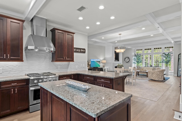 1510 Match Point Ln Unit 303, Panama City Beach, FL 32413 - kitchen featuring wall chimney exhaust hood, high end stainless steel range oven, open floor plan, light wood finished floors, and backsplash