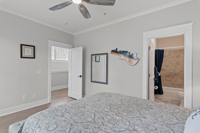 1510 Match Point Ln Unit 303, Panama City Beach, FL 32413 - bedroom with crown molding, wood finished floors, connected bathroom, and a ceiling fan