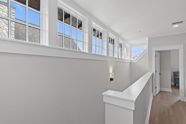 1510 Match Point Ln Unit 303, Panama City Beach, FL 32413 - hall with healthy amount of natural light, light wood finished floors, ornamental molding, and recessed lighting