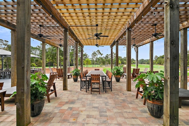 1510 Match Point Ln Unit 303, Panama City Beach, FL 32413 - view of patio featuring a ceiling fan, outdoor dining area, and a pergola