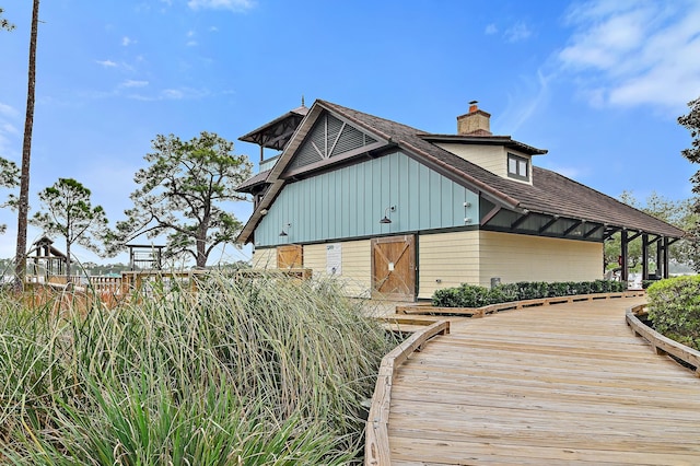 1510 Match Point Ln Unit 303, Panama City Beach, FL 32413 - rear view of property with a chimney and board and batten siding