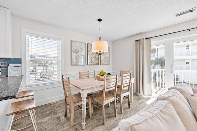 11 Beachside Dr Unit 323, Santa Rosa Beach, FL 32459 - dining space featuring light wood-style floors and a textured ceiling