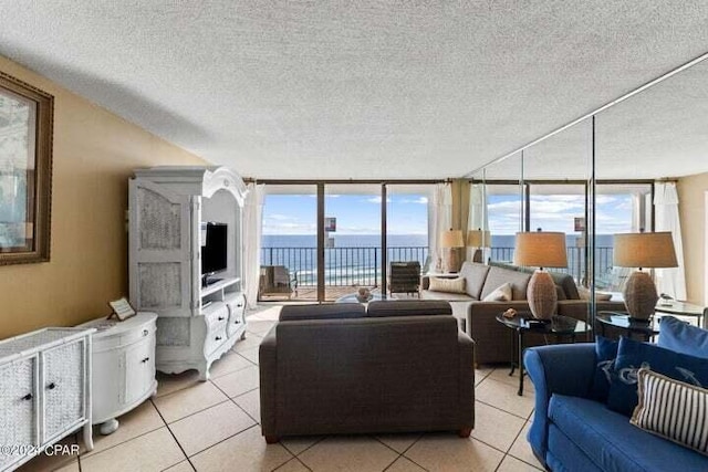 11483 Front Beach Rd Unit 1004, Panama City Beach, FL 32407 - living room featuring a textured ceiling, plenty of natural light, light tile patterned floors, and a wall of windows