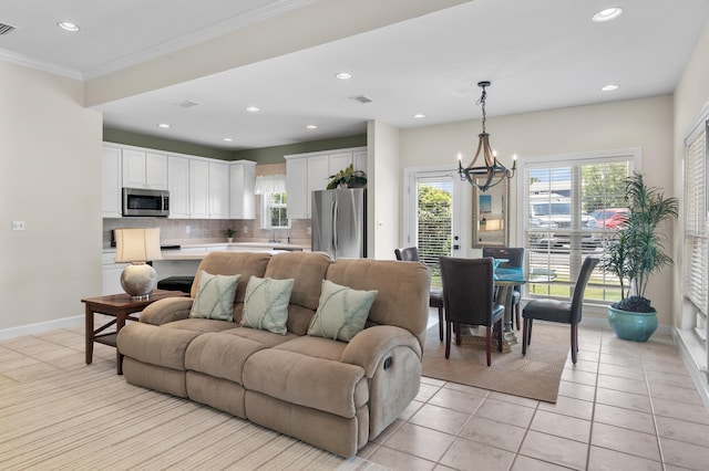 113 Mantero Way, Destin, FL 32541 - living area featuring light tile patterned floors, a chandelier, recessed lighting, and crown molding