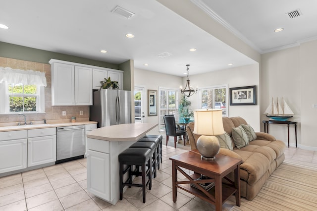 113 Mantero Way, Destin, FL 32541 - kitchen featuring stainless steel appliances, light countertops, healthy amount of natural light, white cabinetry, and recessed lighting