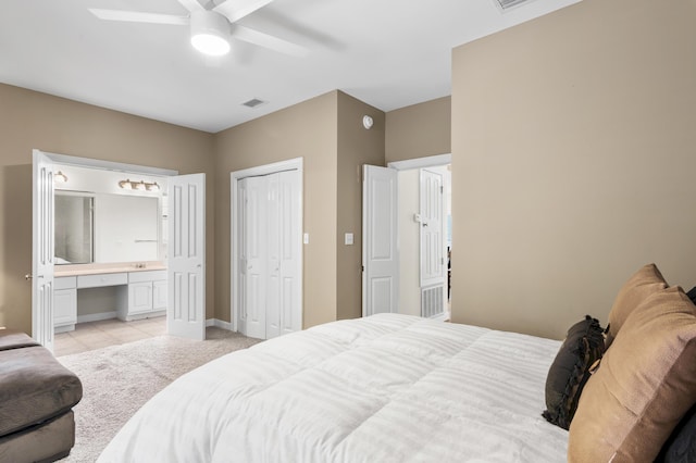 113 Mantero Way, Destin, FL 32541 - bedroom featuring built in desk, connected bathroom, ceiling fan, light tile patterned floors, and a closet