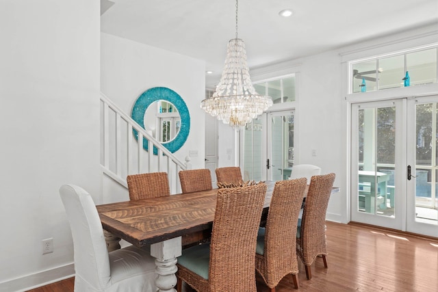 97 Red Cedar Way, Santa Rosa Beach, FL 32459 - dining room featuring french doors, a chandelier, wood finished floors, stairway, and recessed lighting