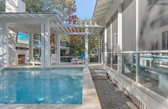 97 Red Cedar Way, Santa Rosa Beach, FL 32459 - outdoor pool with a warm lit fireplace, ceiling fan, and a patio area