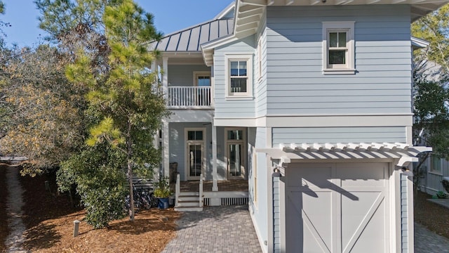 97 Red Cedar Way, Santa Rosa Beach, FL 32459 - view of front facade featuring a balcony, a standing seam roof, a metal roof, and an attached garage