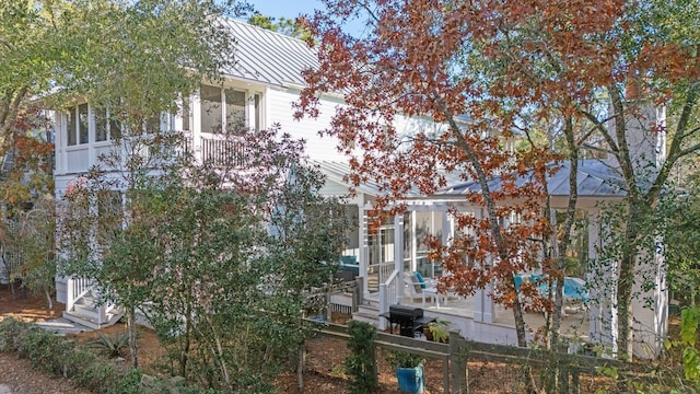 97 Red Cedar Way, Santa Rosa Beach, FL 32459 - view of side of property featuring a standing seam roof, a metal roof, a patio, and a sunroom