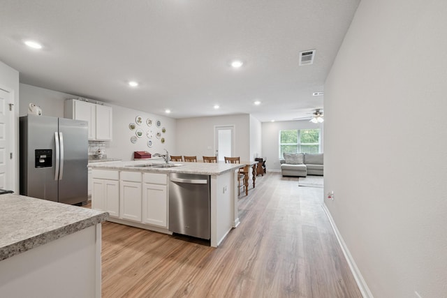 6721 Sarah Ann Way, Laurel Hill, FL 32567 - kitchen with appliances with stainless steel finishes, light wood-style floors, white cabinets, light countertops, and recessed lighting