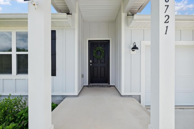 6721 Sarah Ann Way, Laurel Hill, FL 32567 - view of exterior entry featuring board and batten siding and a garage