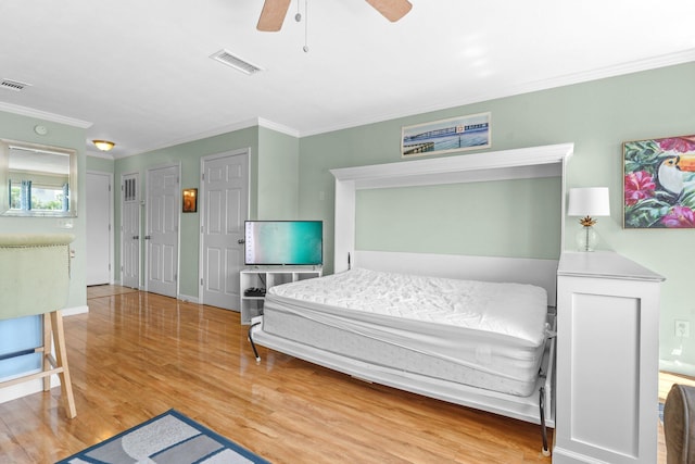 445 Gulf Shore Dr Unit 206, Destin, FL 32541 - bedroom with ornamental molding, wood finished floors, and a ceiling fan