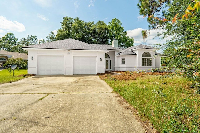 1005 Shalimar Point Dr, Shalimar, FL 32579 - ranch-style house with driveway, stucco siding, a chimney, an attached garage, and a front lawn