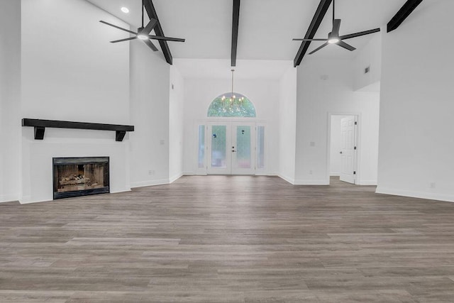 1005 Shalimar Point Dr, Shalimar, FL 32579 - unfurnished living room featuring a ceiling fan, high vaulted ceiling, beam ceiling, a fireplace, and wood finished floors